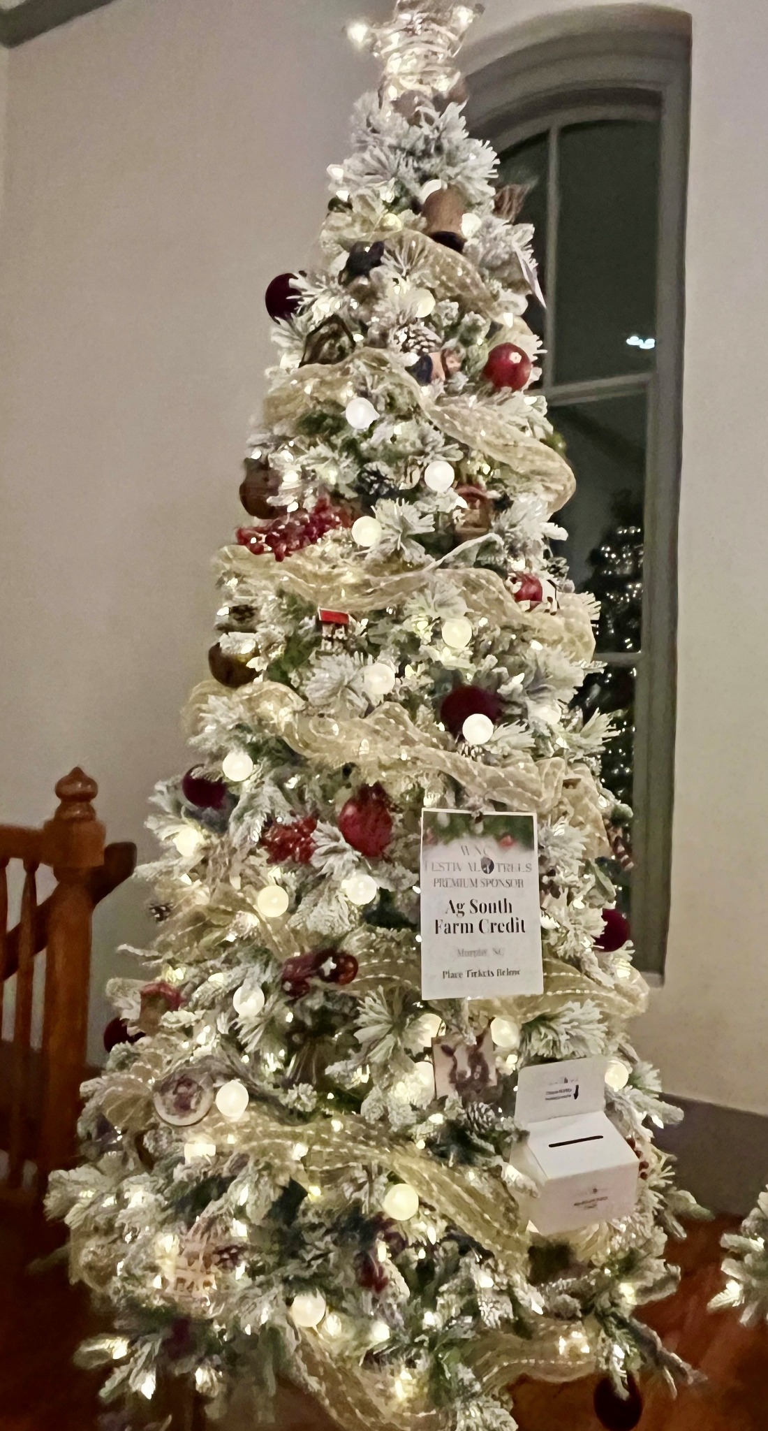 A glowing tree inspired by community and agriculture at the WNC Festival of Trees in Hayesville, North Carolina