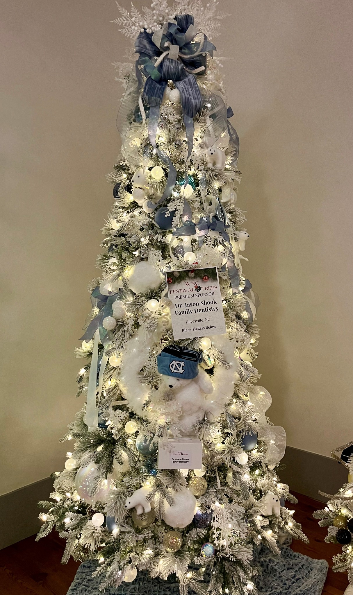 A Carolina-blue and white tree filled with snowy polar bear charm at the WNC Festival of Trees in Hayesville, North Carolina
