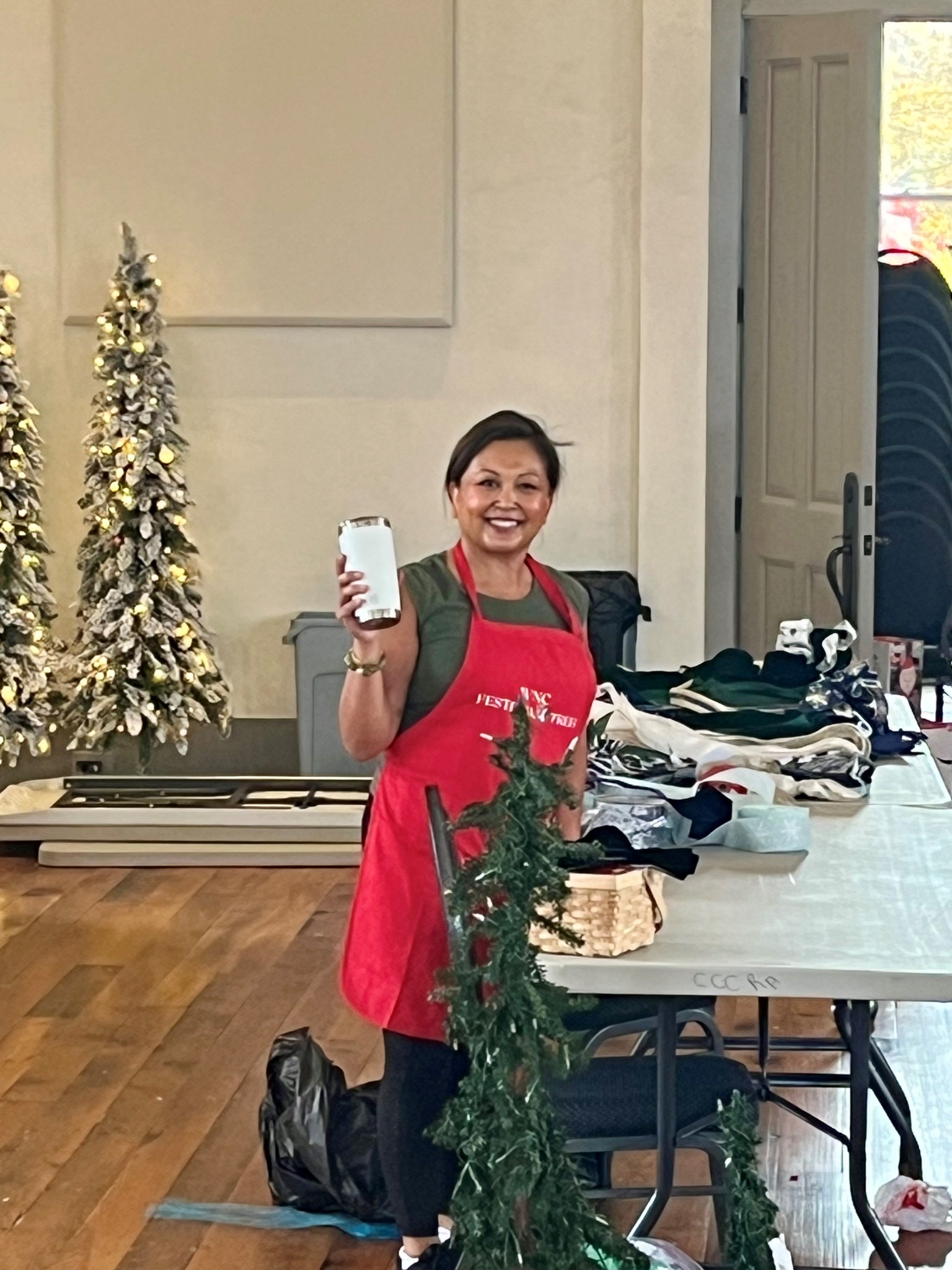 A cheerful volunteer helping prepare decorations for the festival at the WNC Festival of Trees in Hayesville, North Carolina