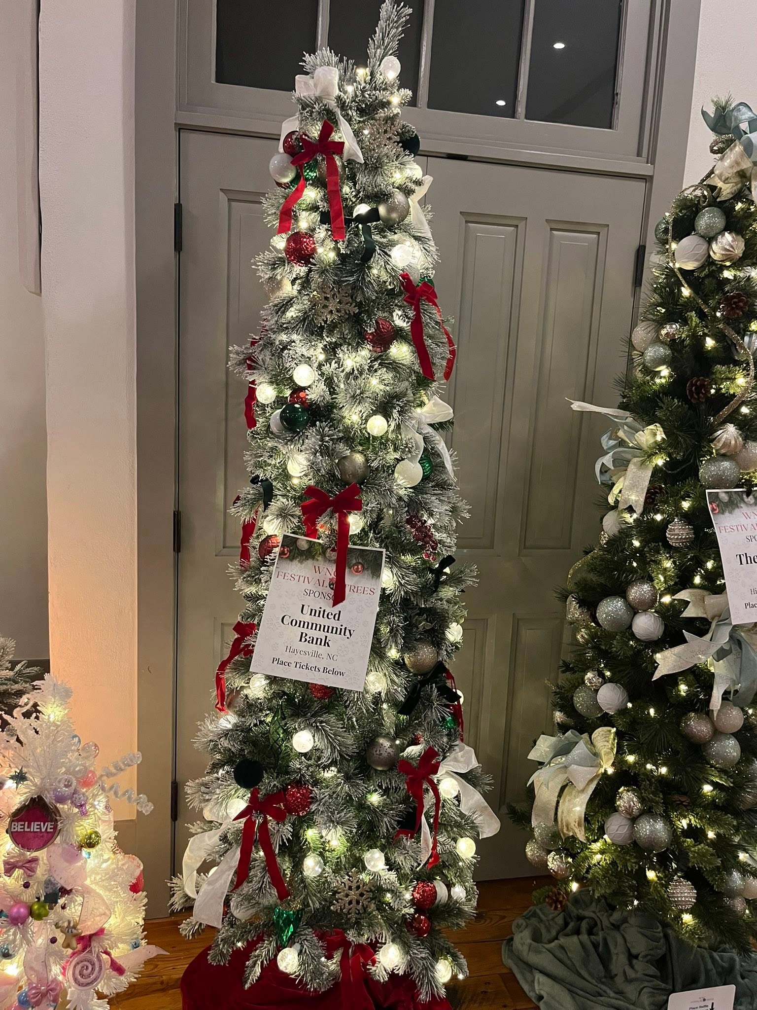 Classic red, white, green, and silver Christmas tree at the WNC Festival of Trees in Hayesville, North Carolina